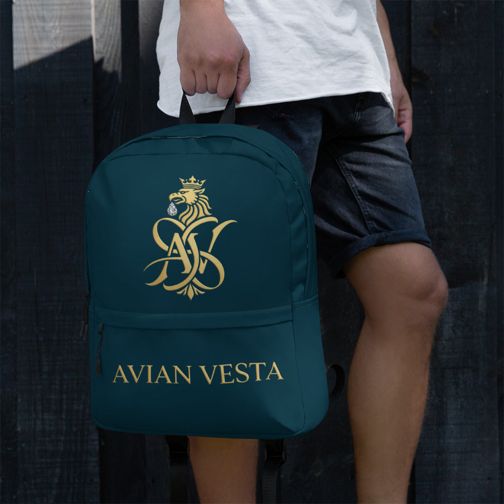 Avian Vesta Signature Backpack Blue Whale carried by hand with gold logo